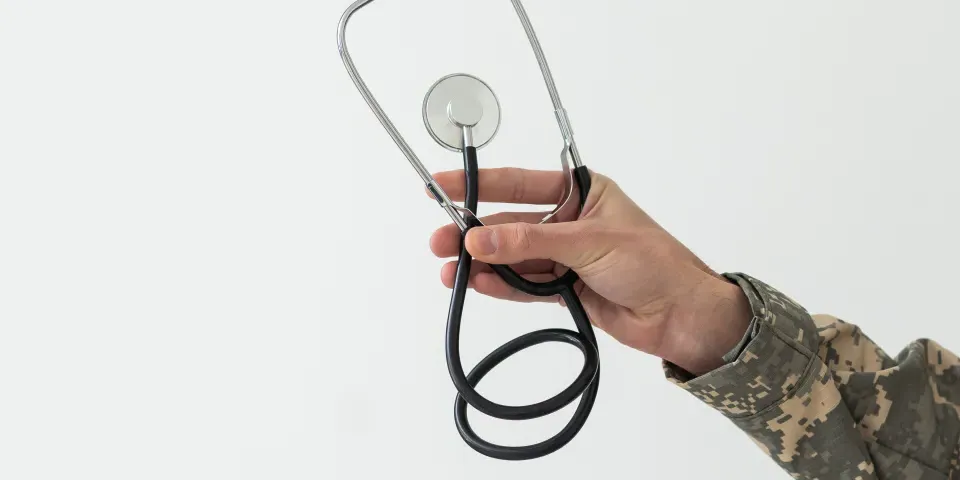 Young man army soldier holding stethoscope